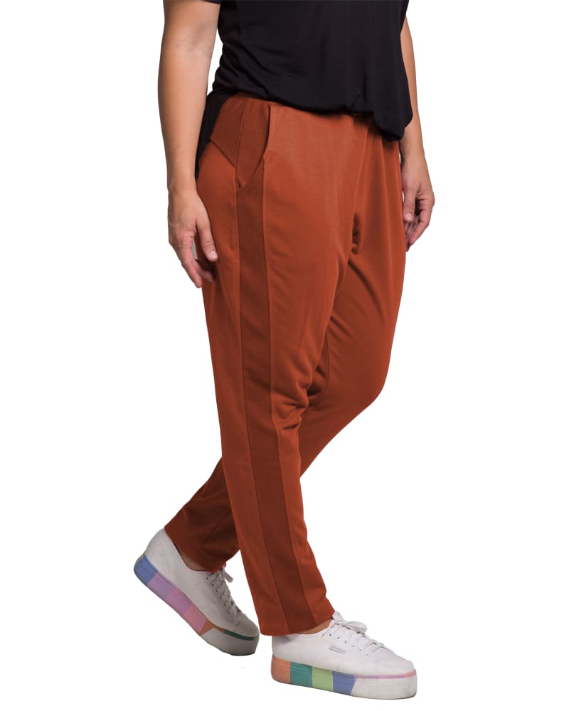 Side of a model wearing a size 1X Gloria French Terry Jogger in PAPRIKA by Standards & Practices. | dia_product_style_image_id:276367